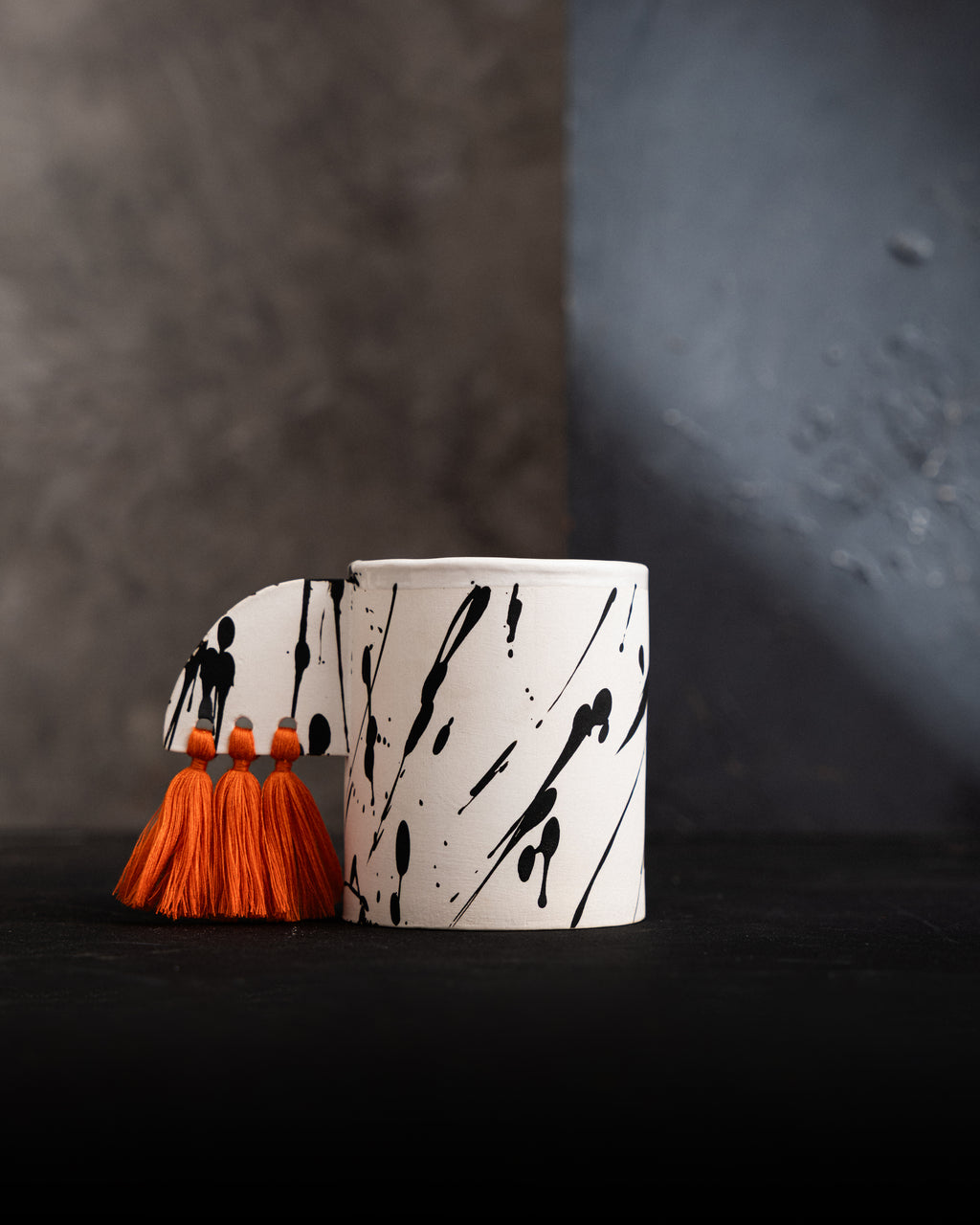 ceramic container with orange tassels