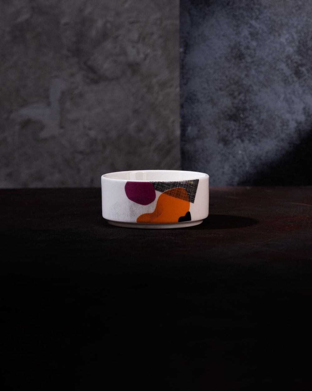 Small white ceramic bowl with colorful abstract design