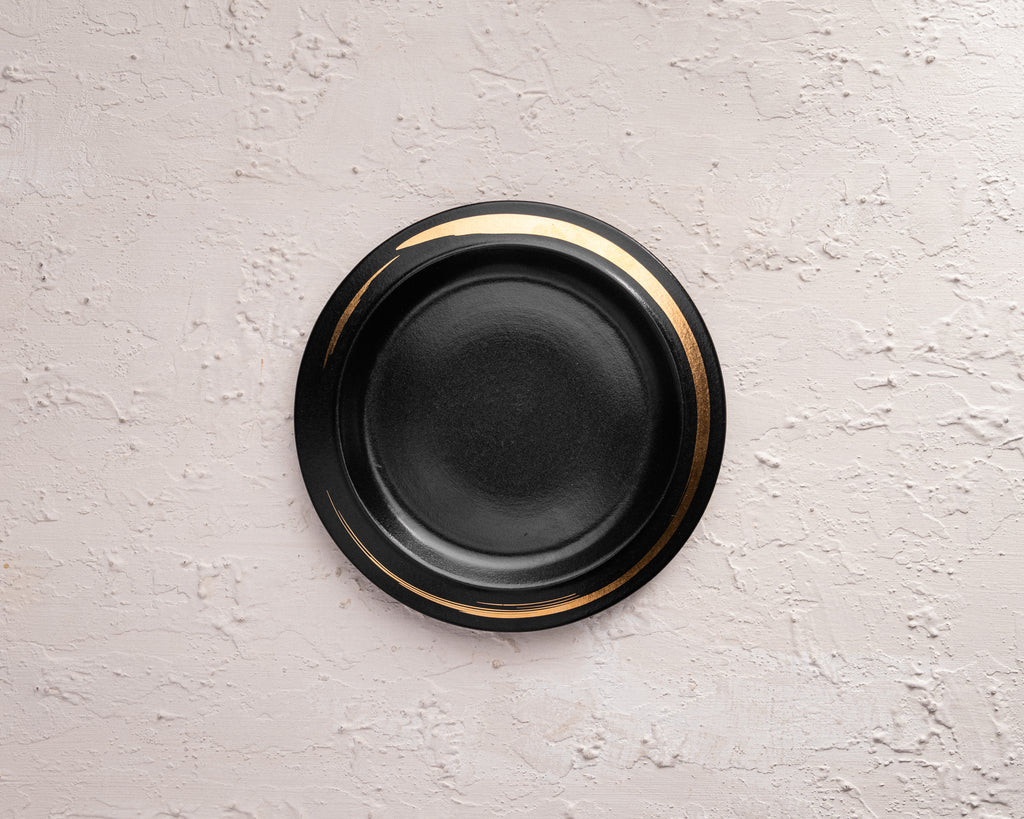 Black plate with gold rim