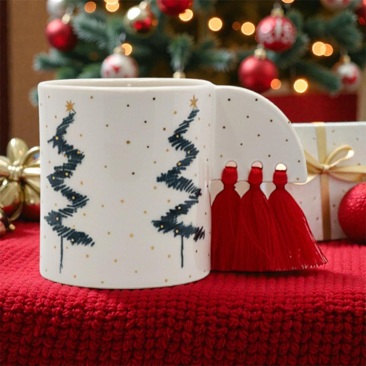 White mug with Christmas tree design on a red surface