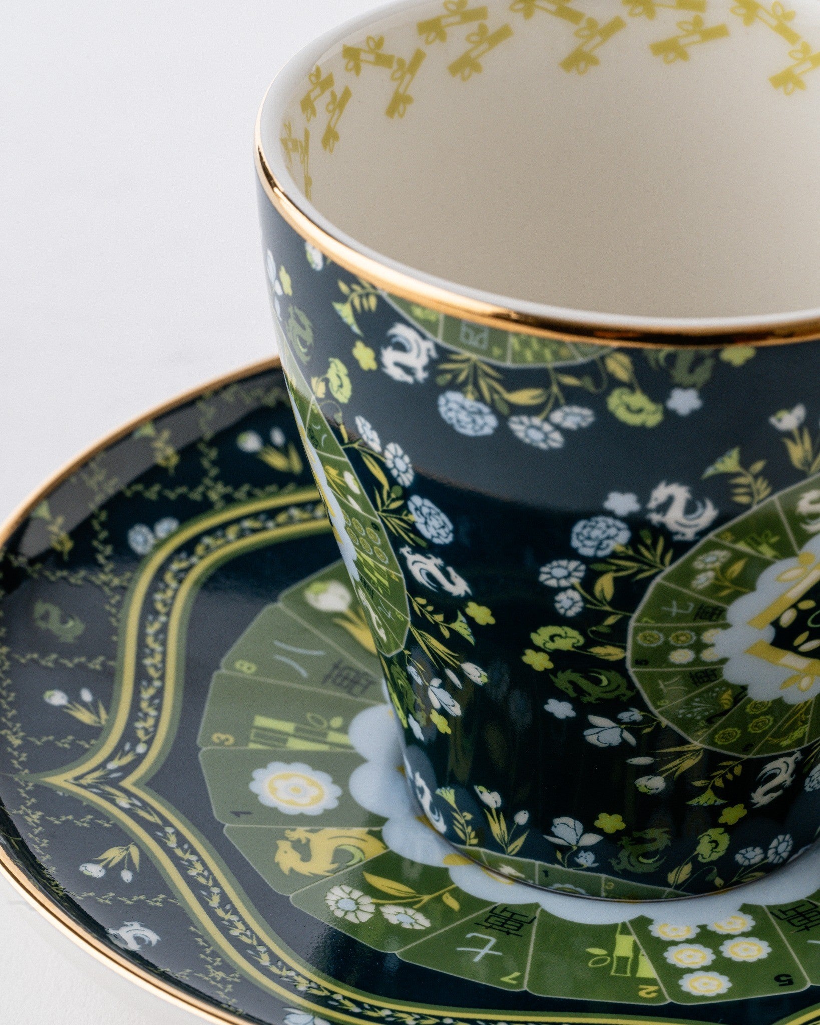 Duali floral-patterned ceramic teacup and saucer with gold detailing