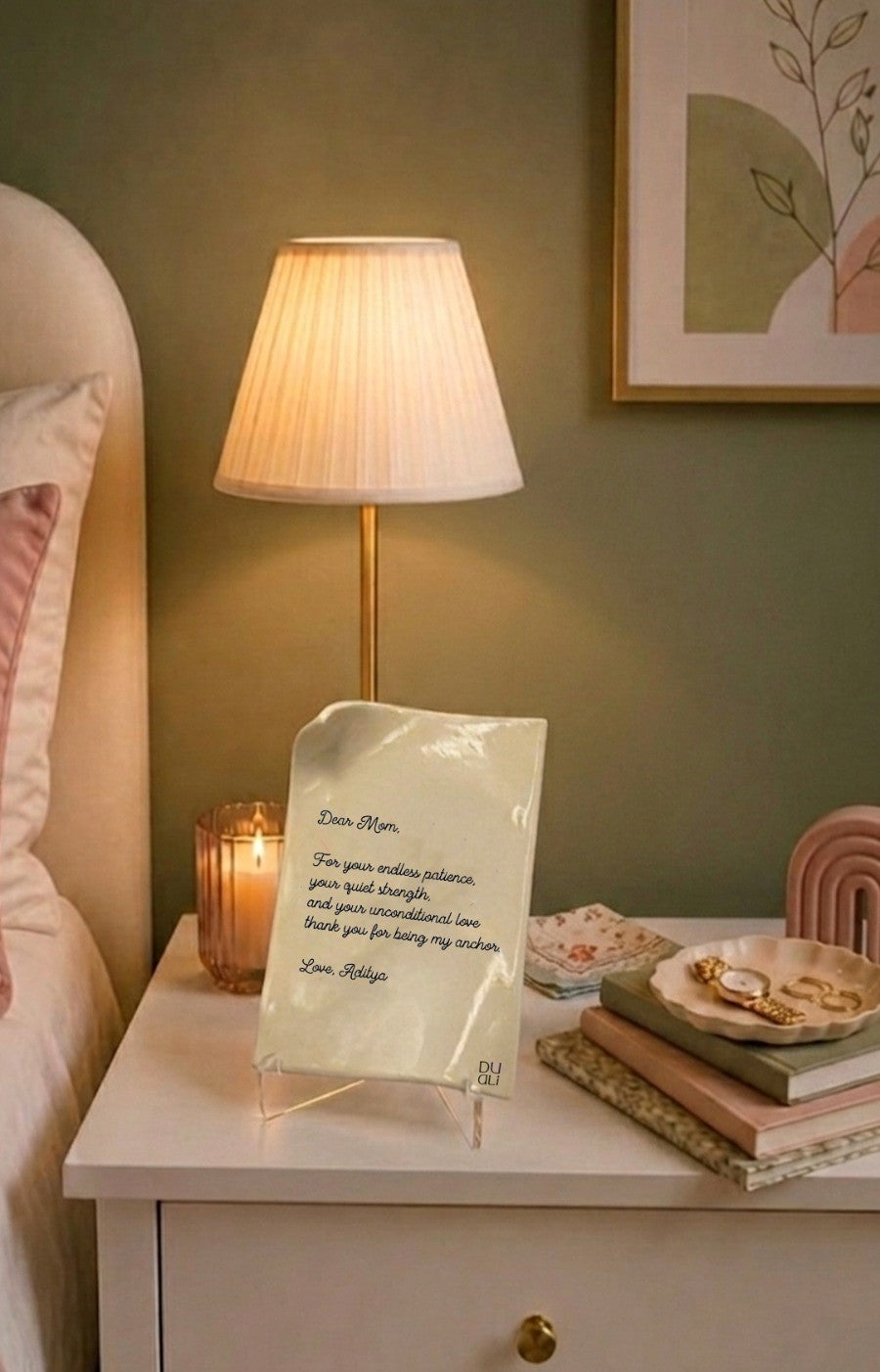 Forever Fold card displayed on stand in bedroom with lamp, books, and warm home decor
