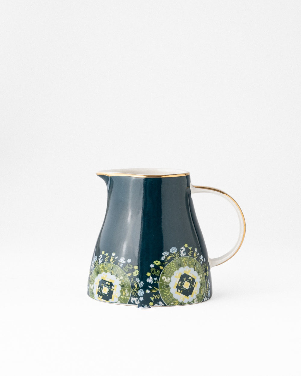 Navy ceramic pitcher with beige handle and green floral pattern on lower body